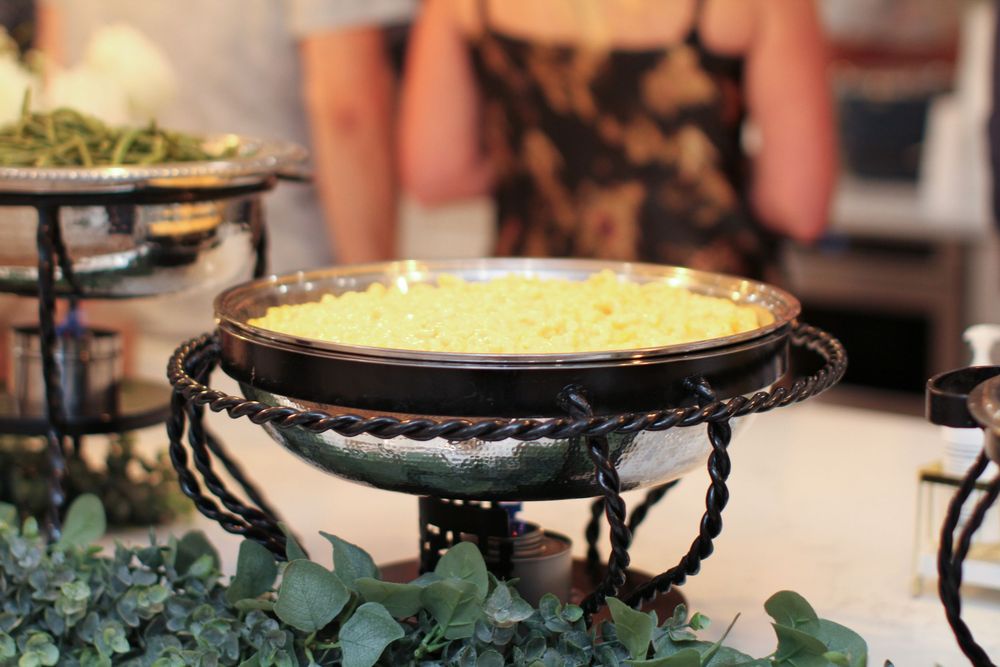 Array of colorful wedding dessert tables with cake stands and multi-tiered displays featuring decadent treats and flowers.