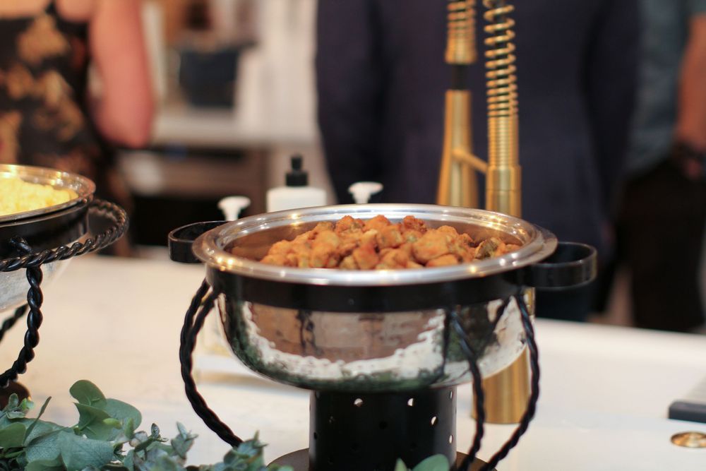 Hot mulled wine and winter spices being poured into ceramic mugs at a festive holiday gathering.