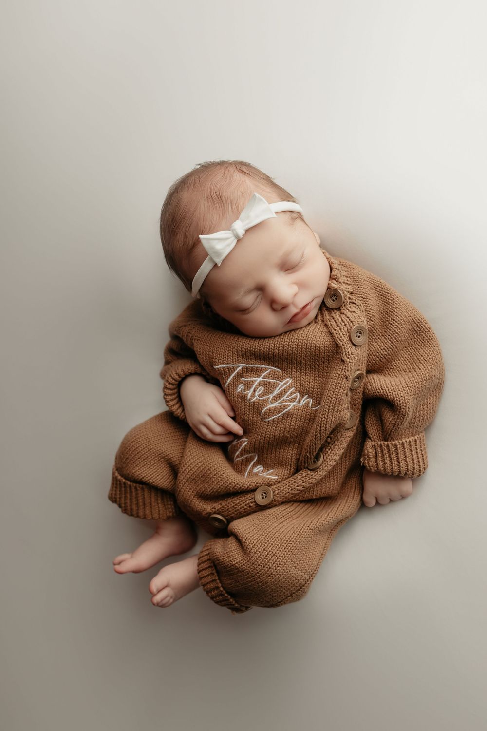 newborn girl in brown jumper, taken by Jen Knightstep, Photographer