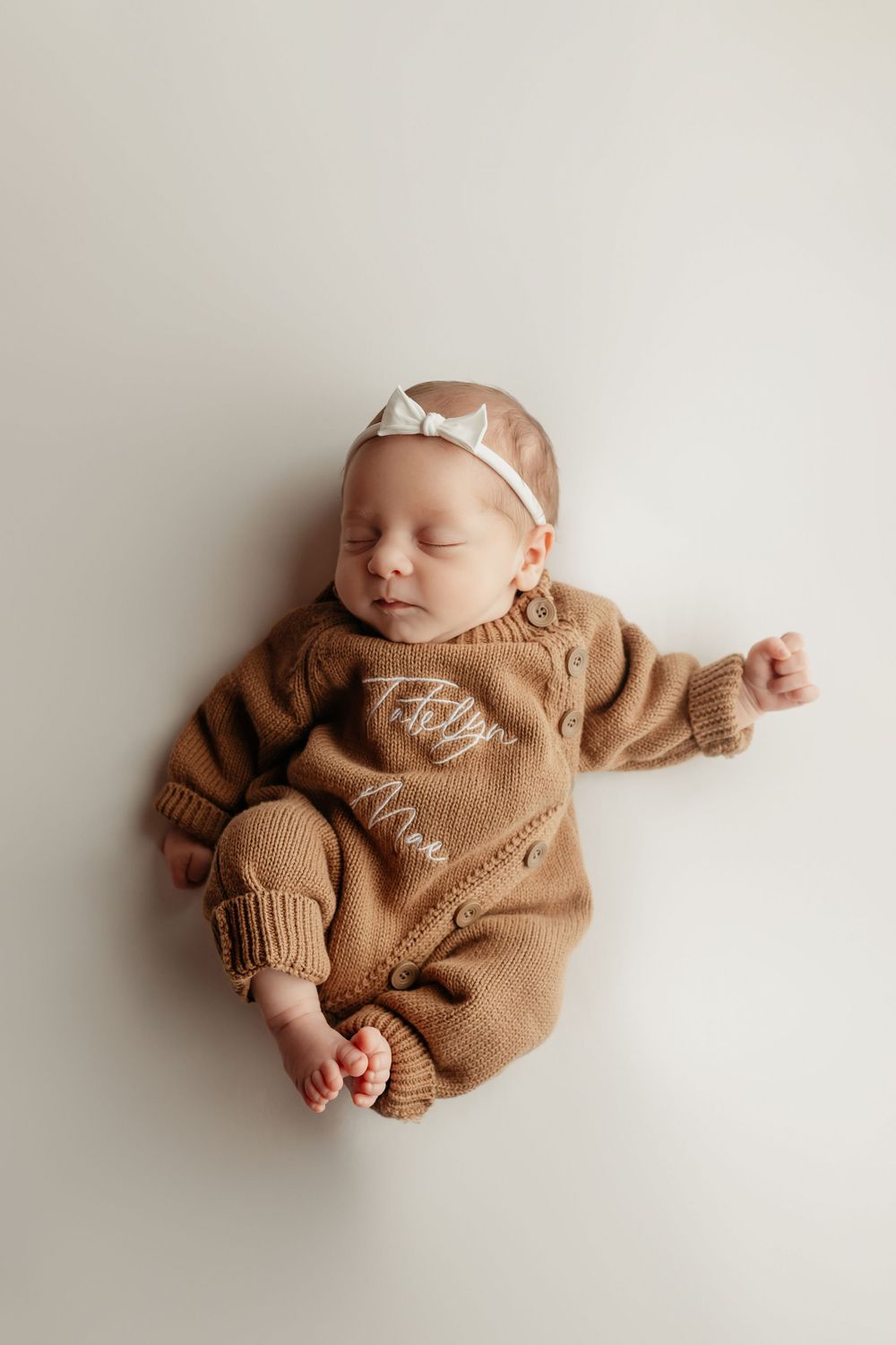 newborn girl in brown jumper, taken by Jen Knightstep, Photographer