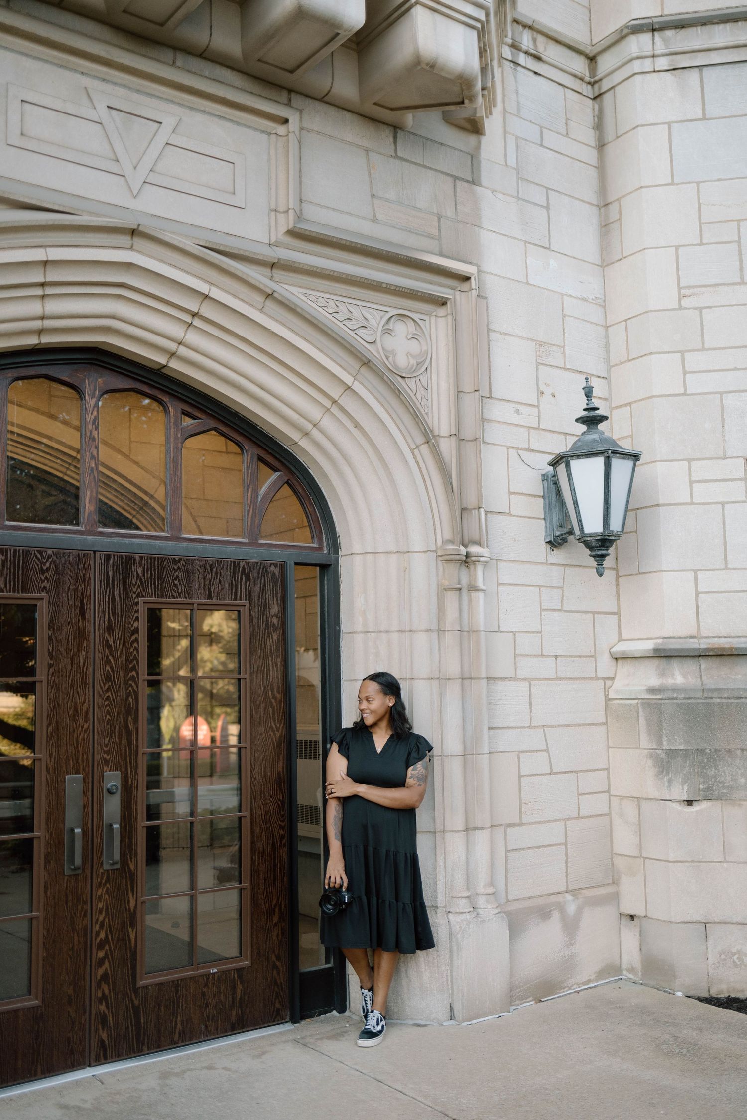 Classic stone building entrance with elegant arched doorways and vintage light fixtures.