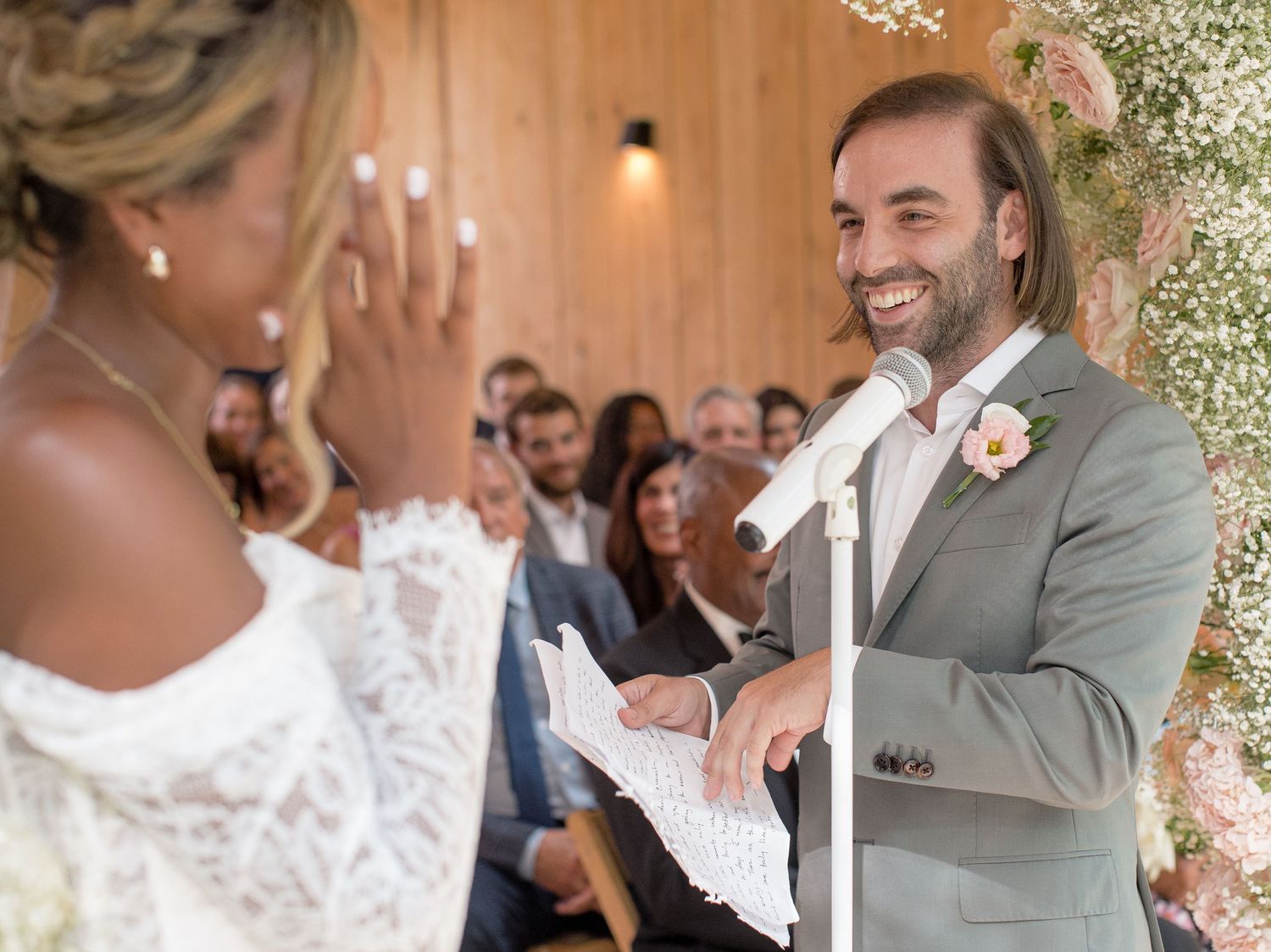 A collection of tender moments from a wedding celebration showing dancing and embracing under an outdoor floral-covered venue.