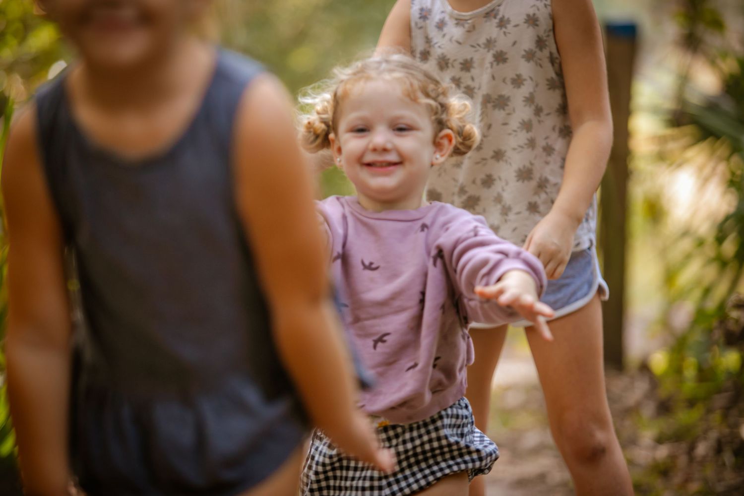 A collection of images showing families and children playing and enjoying outdoor activities in a park setting.