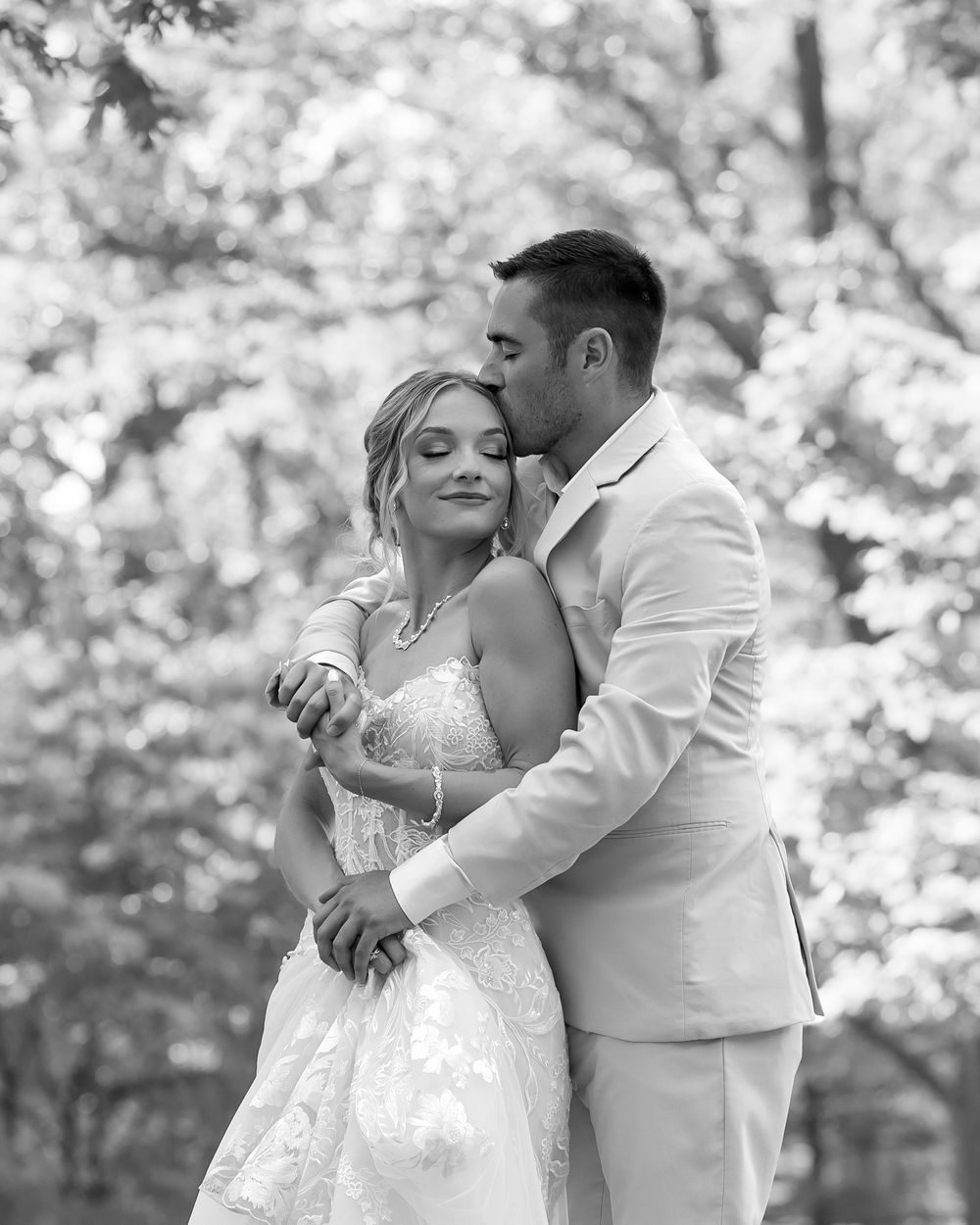Black and white photo sequence captures newlyweds sharing their first dance at an outdoor wedding reception.