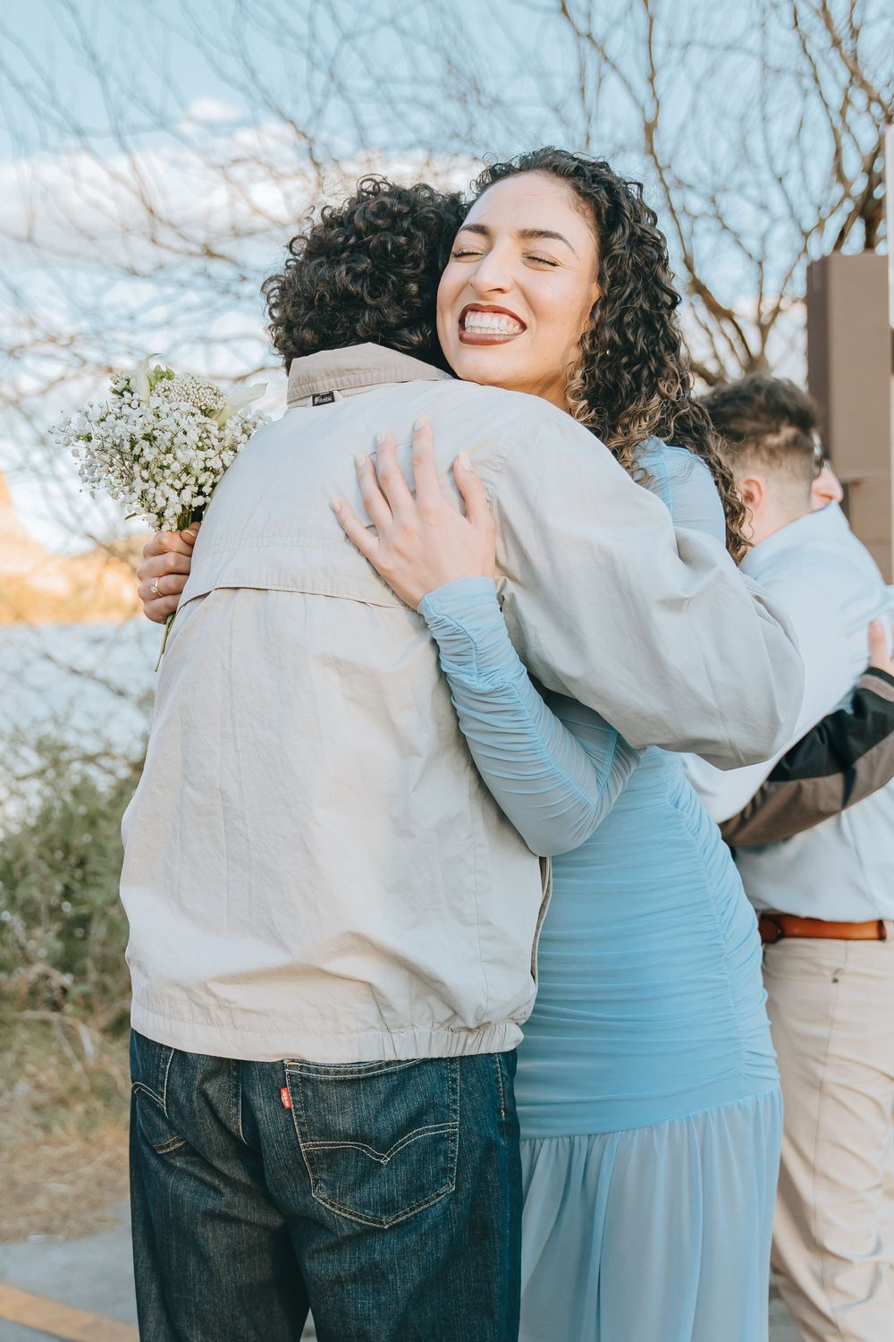 Joyful embraces and celebrations shared between loved ones outdoors.