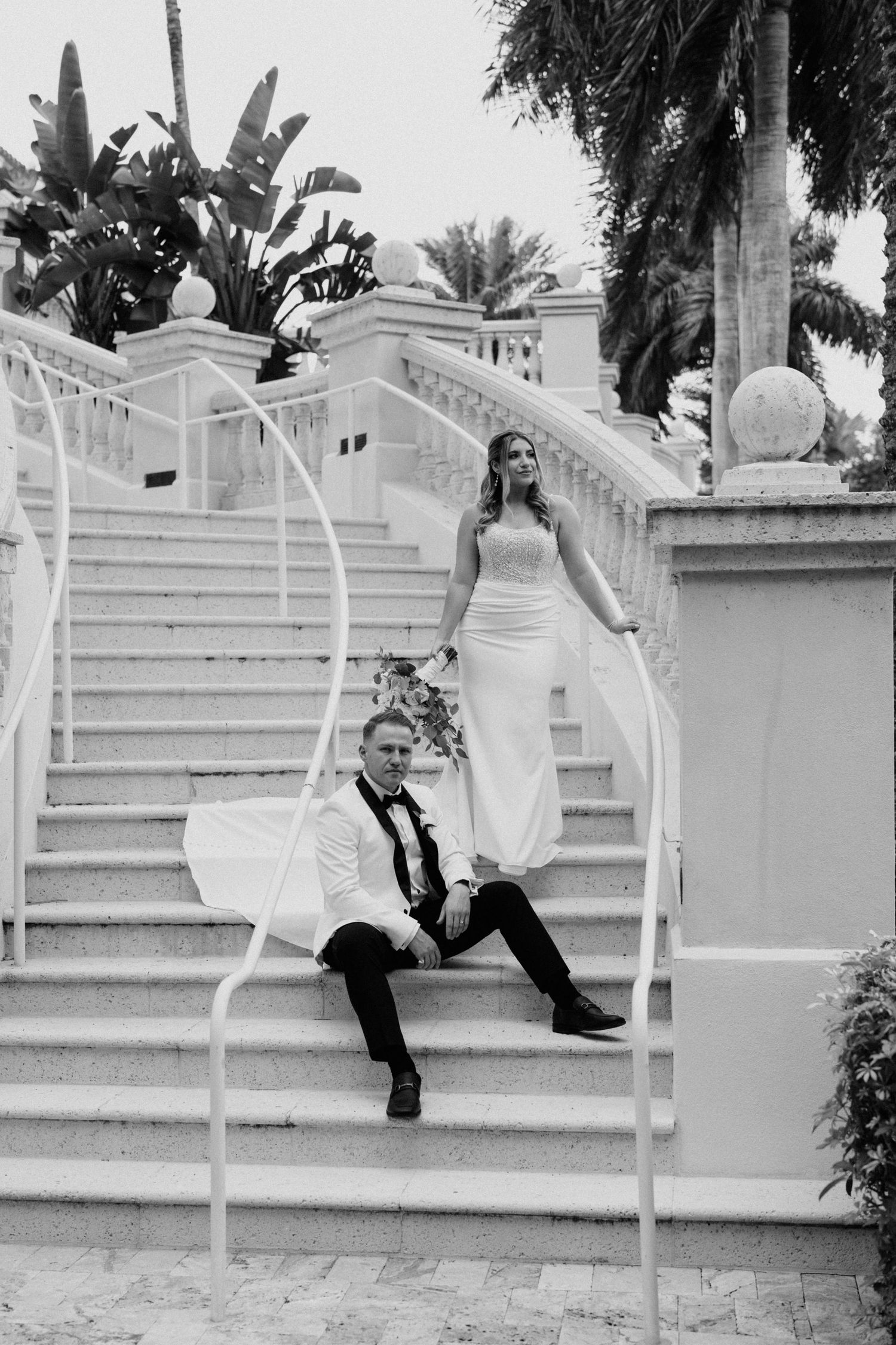 A sequence of black and white photos showing a person in a white dress playfully posing on outdoor stone steps.