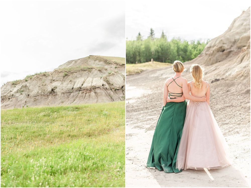 Two formal dresses, one green and one pink, against dramatic rocky cliffs and green grass.
