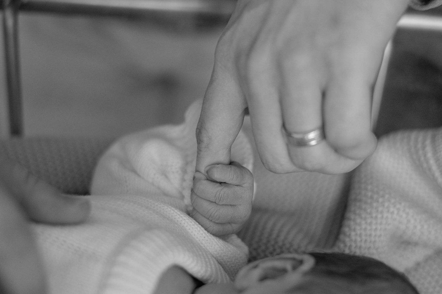 Close-up of hands performing a medical procedure with surgical tools and gauze on a patient.