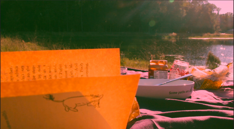 Orange-tinted notebook page with sketches near boats on water.