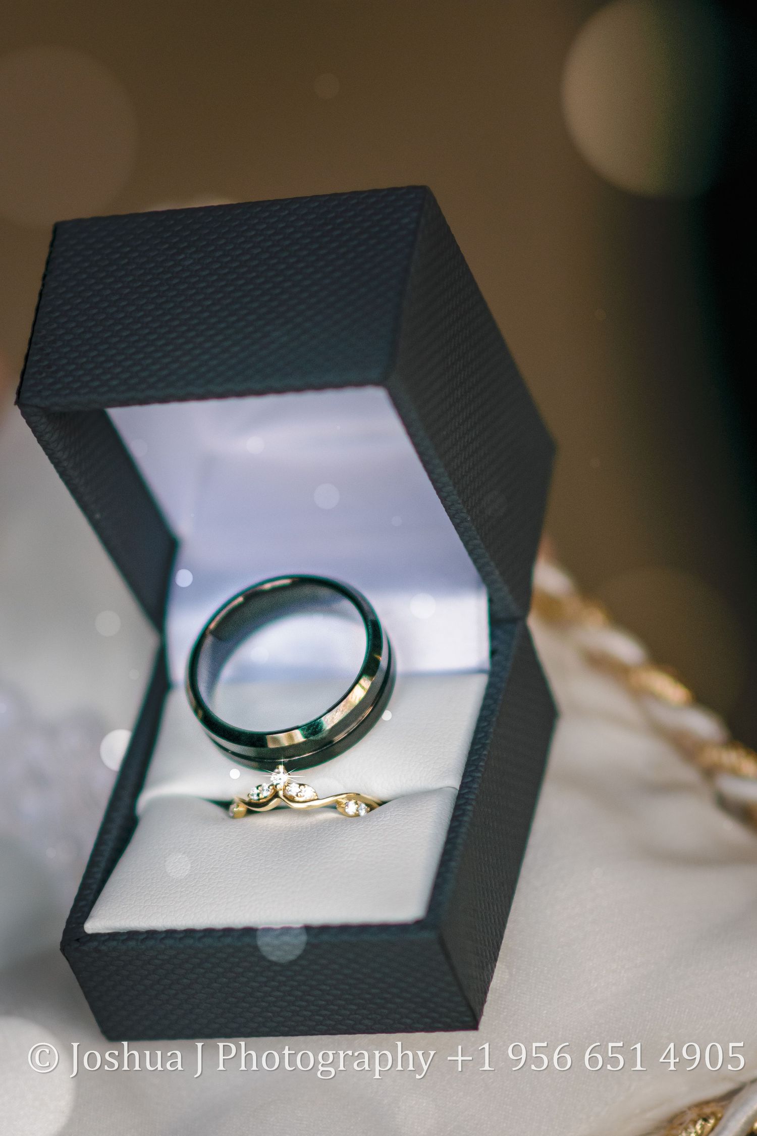 Wedding rings sitting on a pillow.