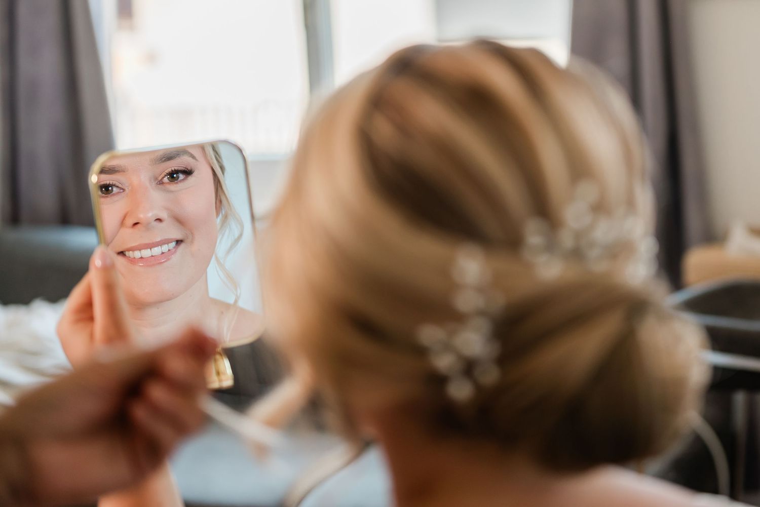 Bride looking at herself in the mirror when getting ready before the wedding in Geneva, Switzerland