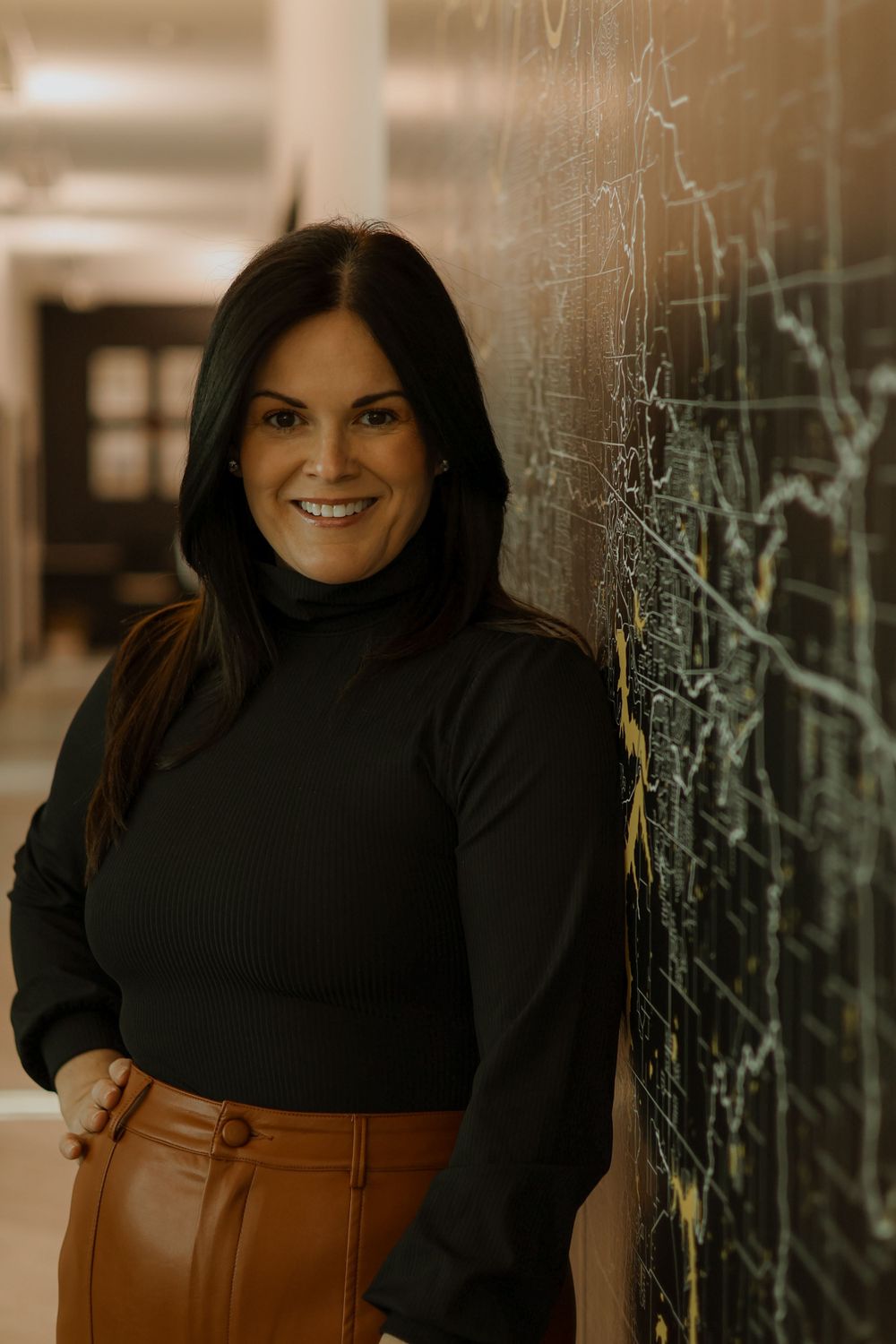 Professional headshots against textured wall showing warm expressions.