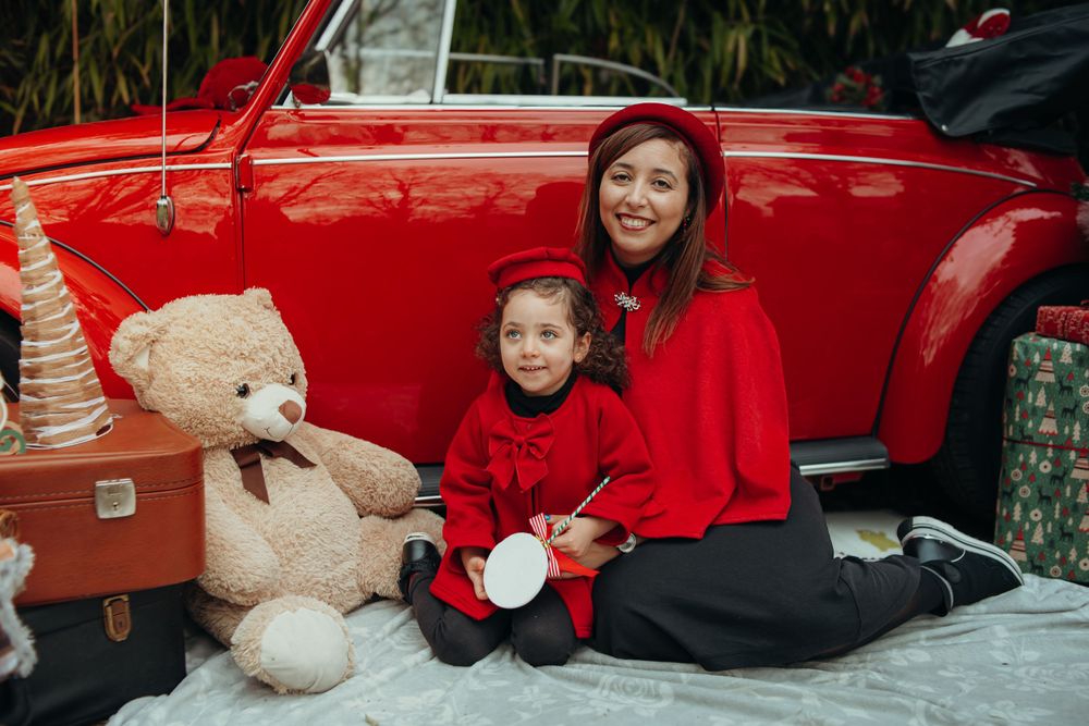Mini-session photo de Noël 2024 avec une coccinelle VW rouge décorée pour les fêtes, créant une ambiance festive et chaleureuse.