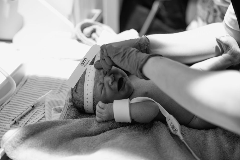 Close up view of medical monitoring equipment attached to a tiny hand.