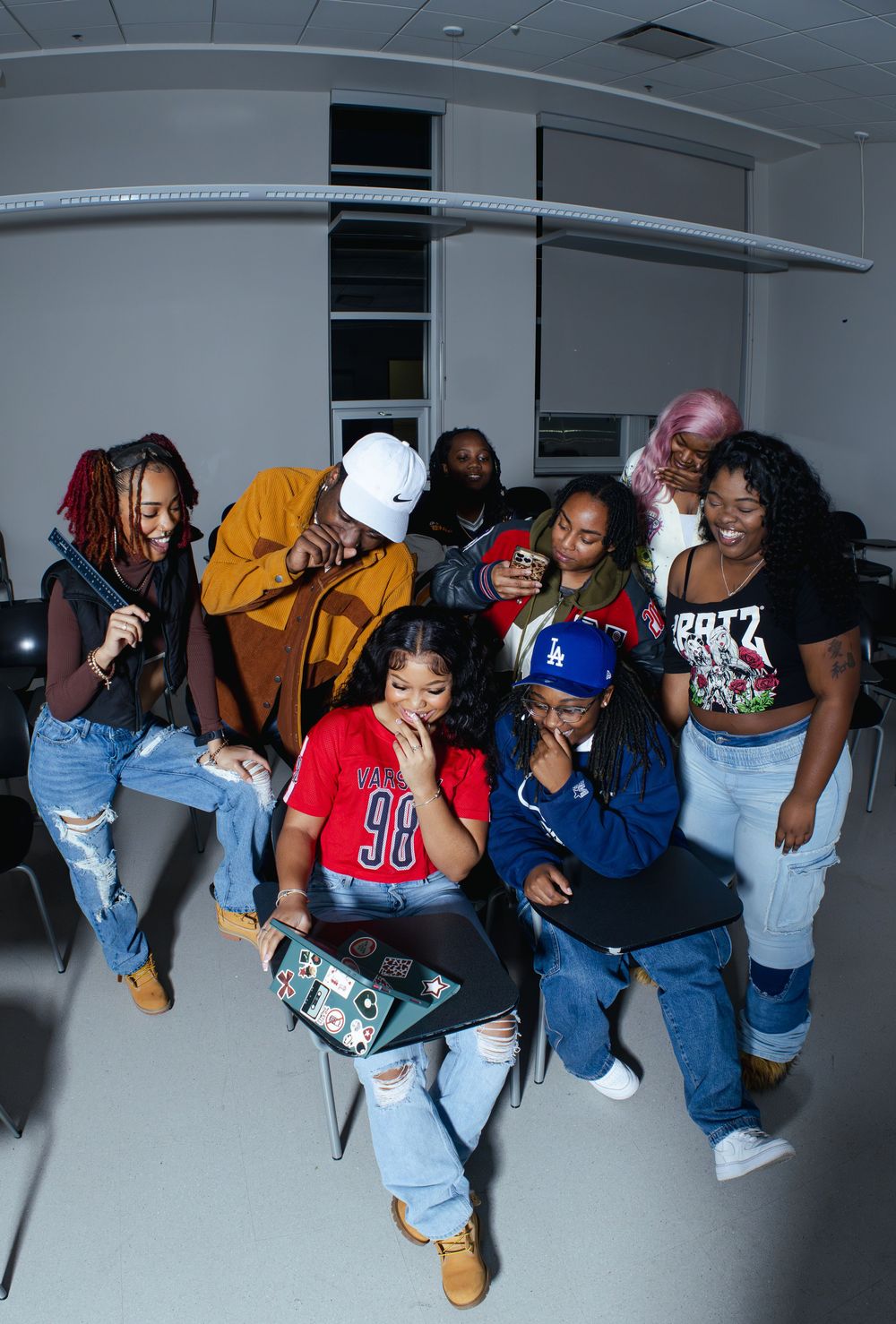 Creative group portrait with people leaning and posing in synchronized formation.