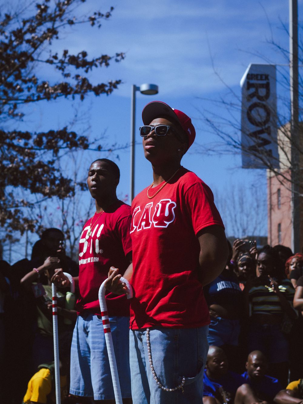 People wearing red t-shirts standing together at an outdoor event.