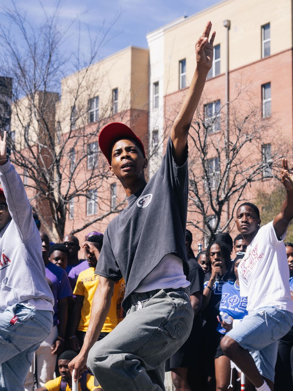 Students dance and celebrate at an outdoor campus event.