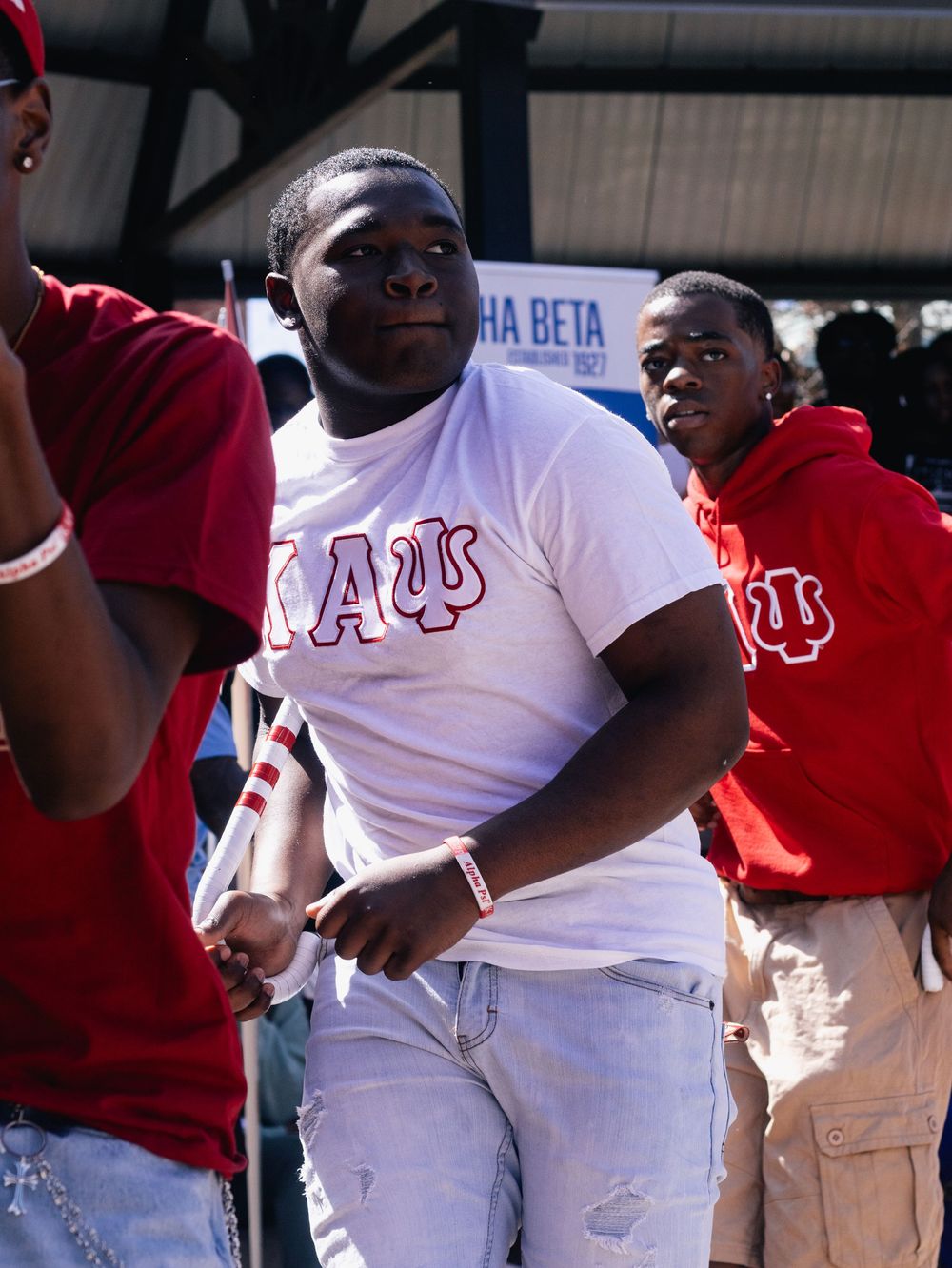 Students in red and white shirts participate in a fraternity gathering.