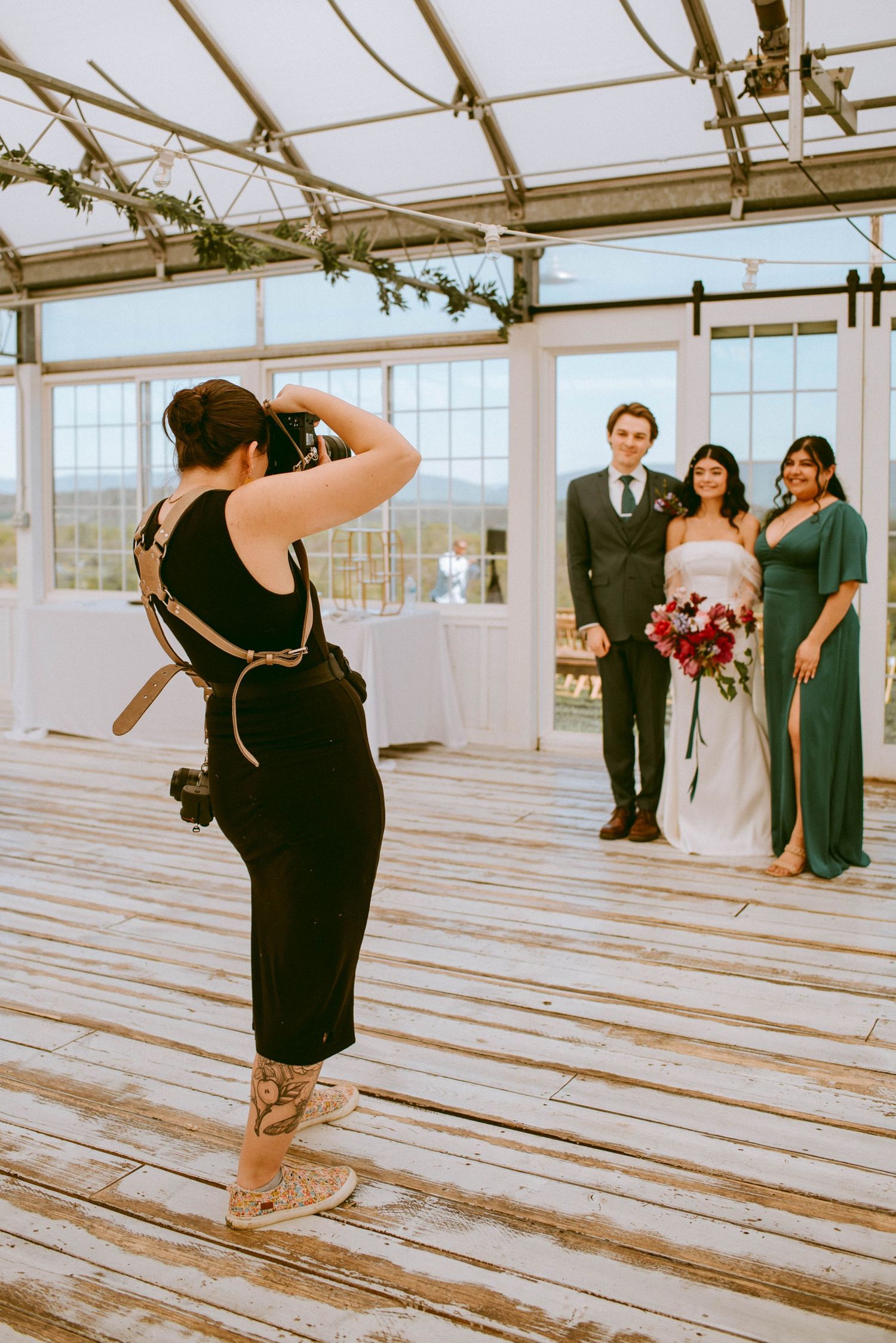 Photographer, Molly, taking a photo of the bride, groom, and siblings