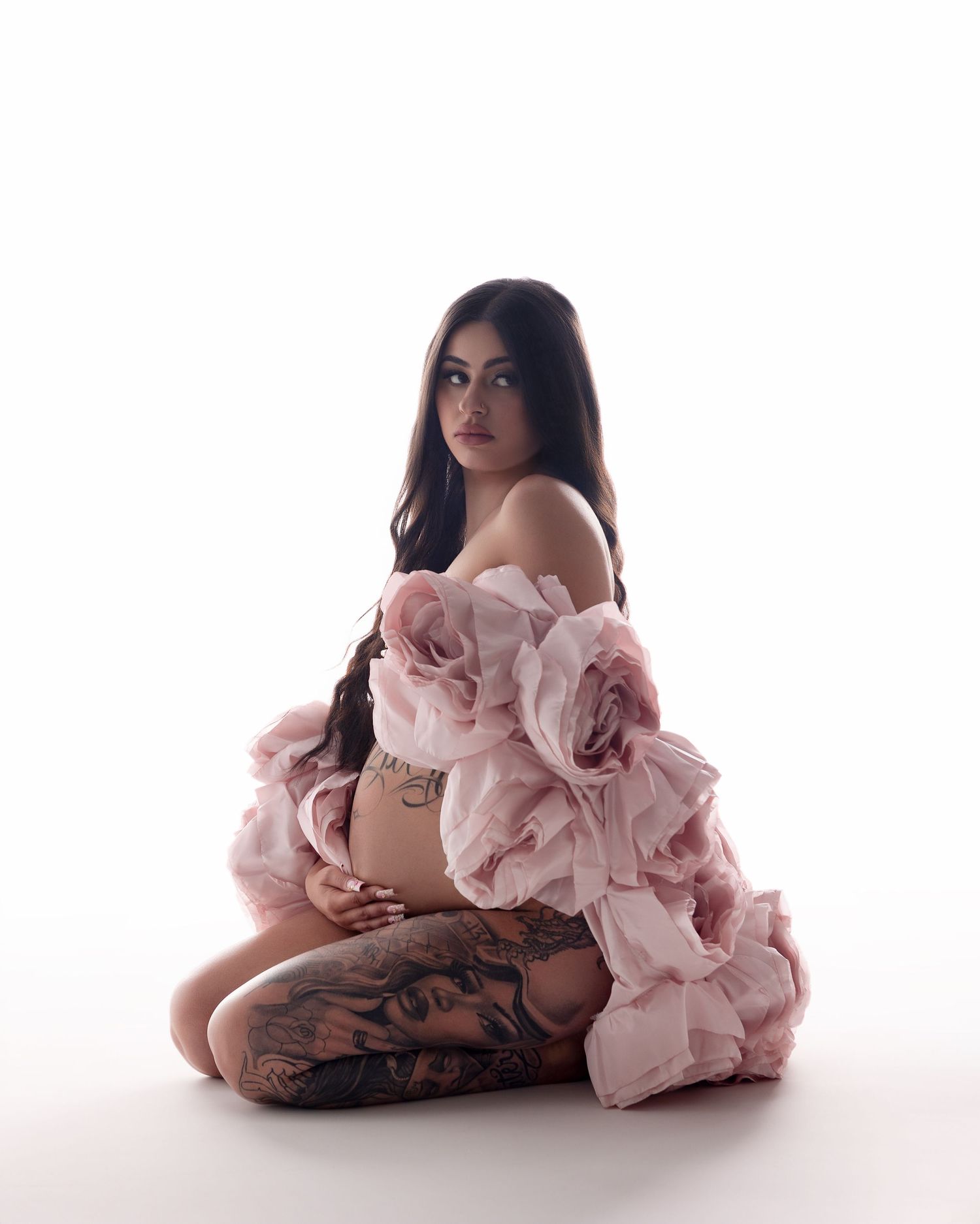 A person in a pink ruffled dress poses gracefully against a white backdrop in three artistic portraits.