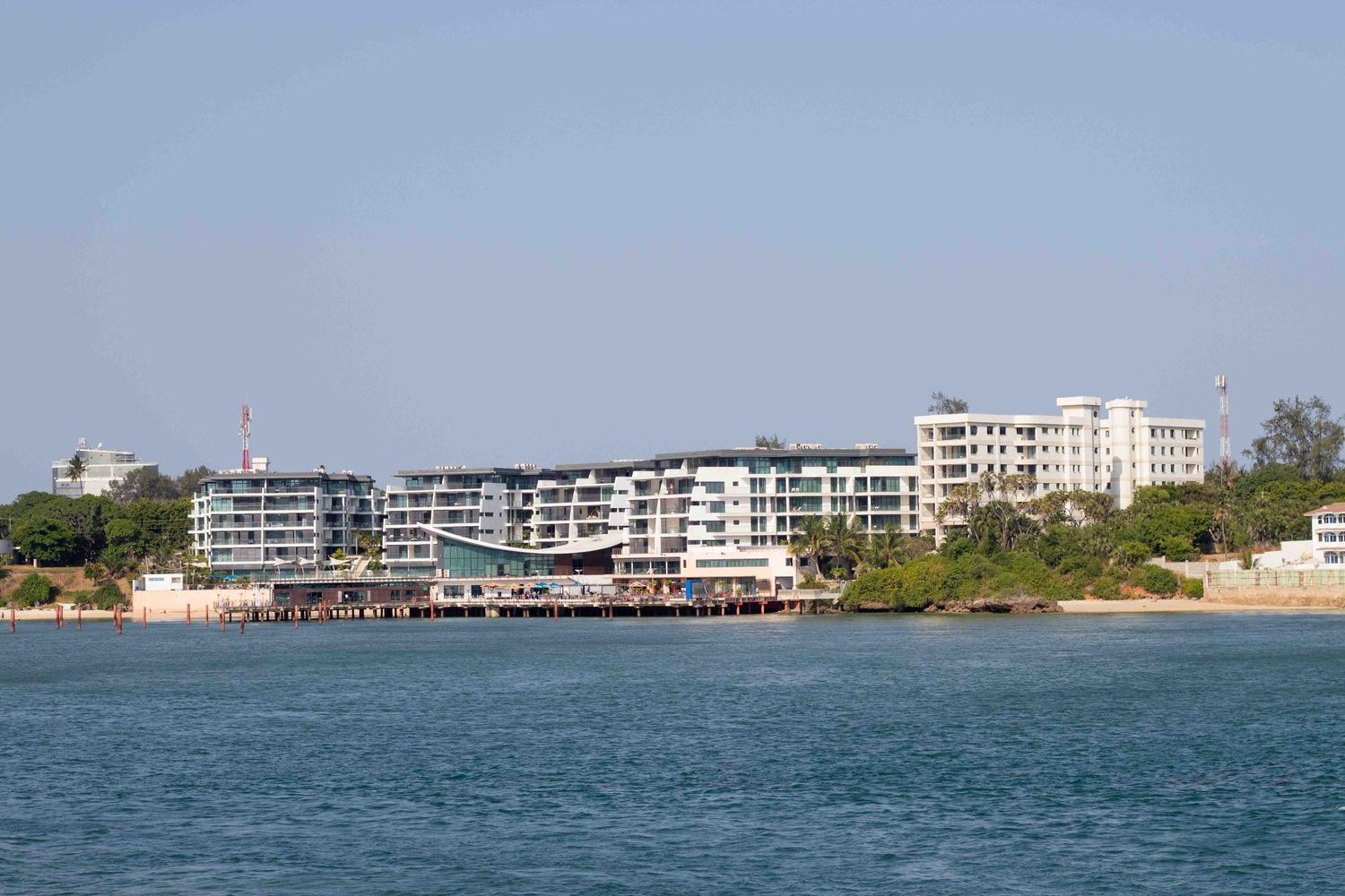 A building at the furthest end of a sea on a sunny day