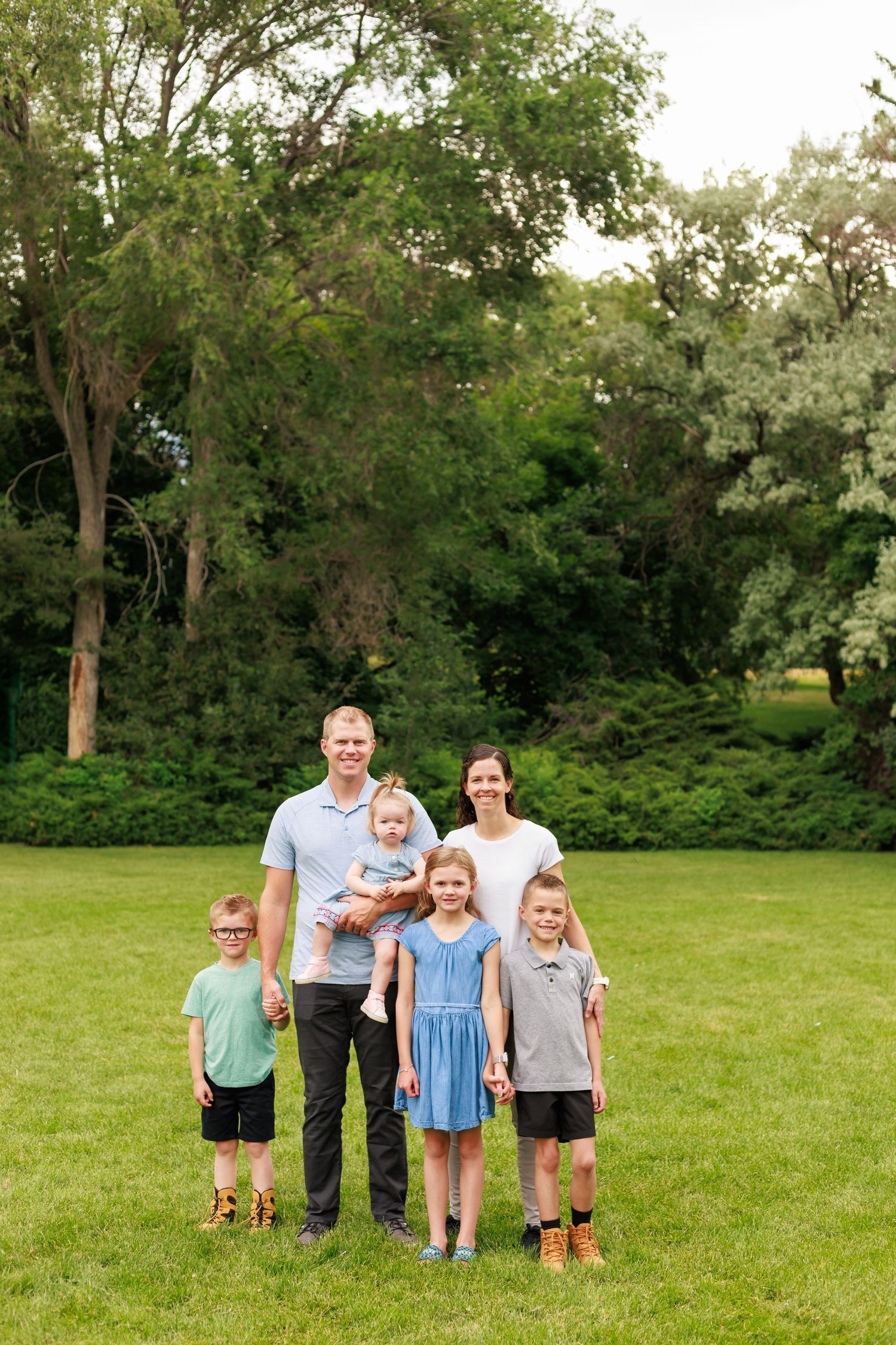 outdoor family portrait with natural light and lush green backdrop
