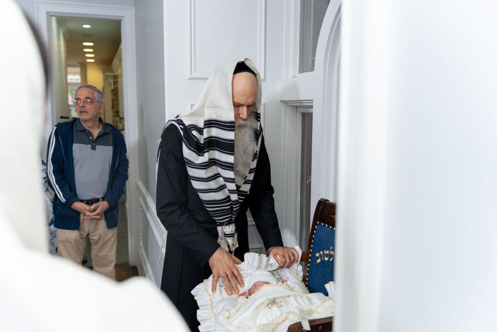 Indoor religious ceremony with people gathered in hallway.