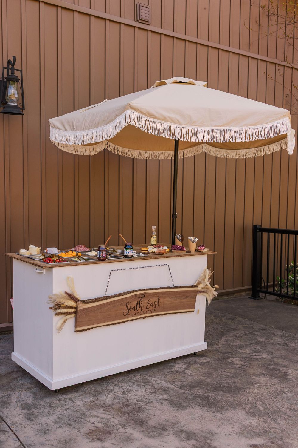 White buffet tables with elegant canopies set up for wedding reception.