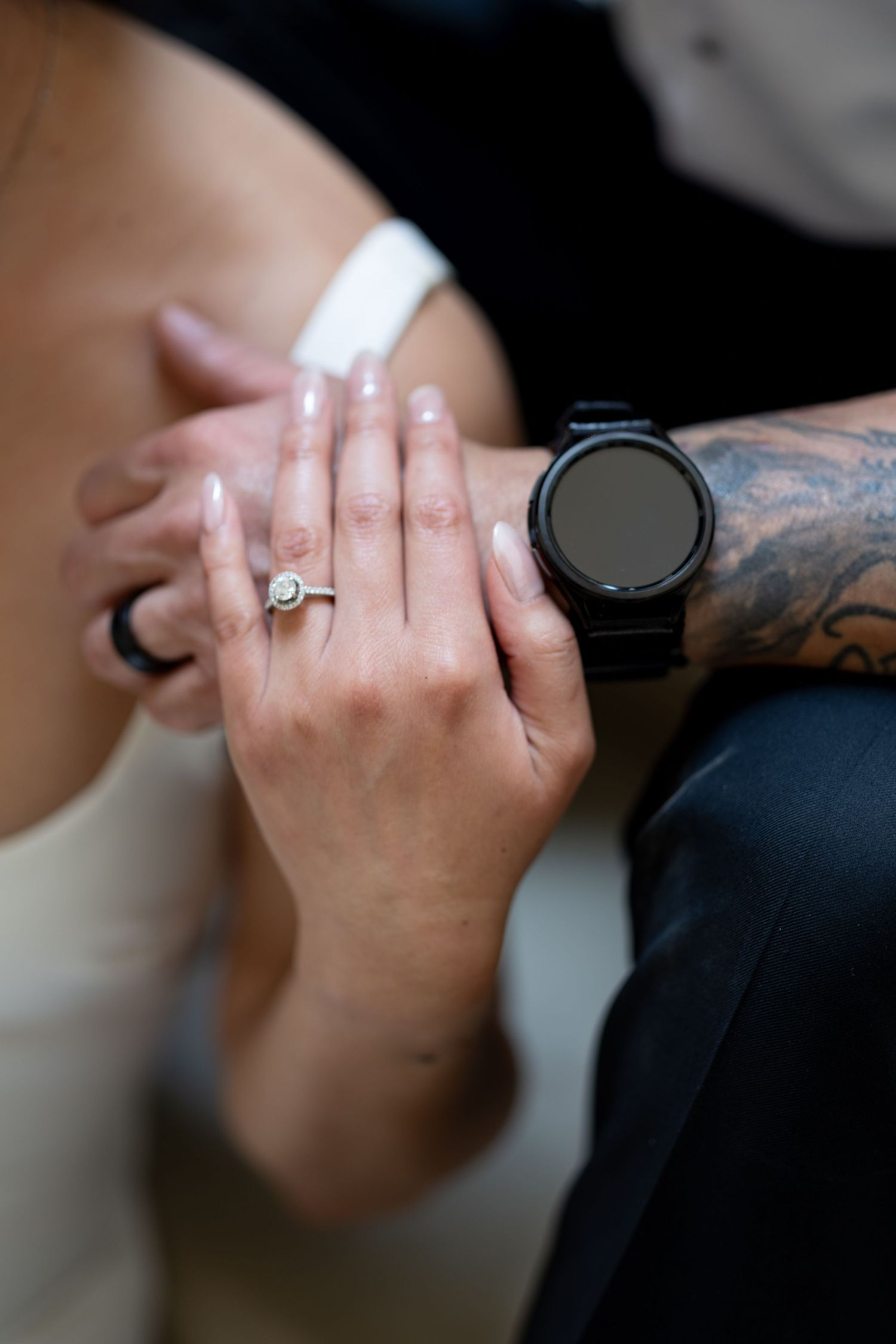 engagement ring and smartwatch with tattoo sleeve visible in romantic proposal moment.  saint paul state capitol mn