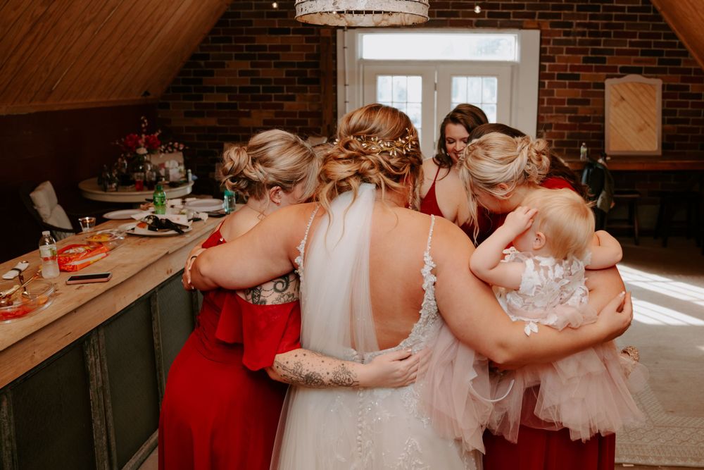 Wedding party members in red dresses preparing for the celebration.