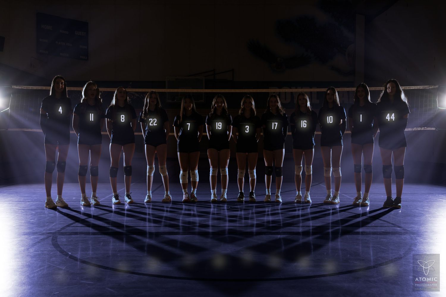 A dramatic photo of a teenage volleyball team.