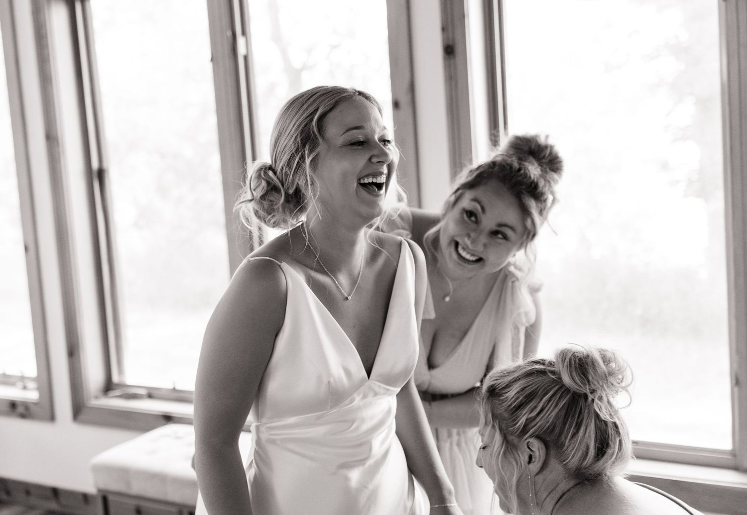 A candid moment of laughter captured during wedding preparations.