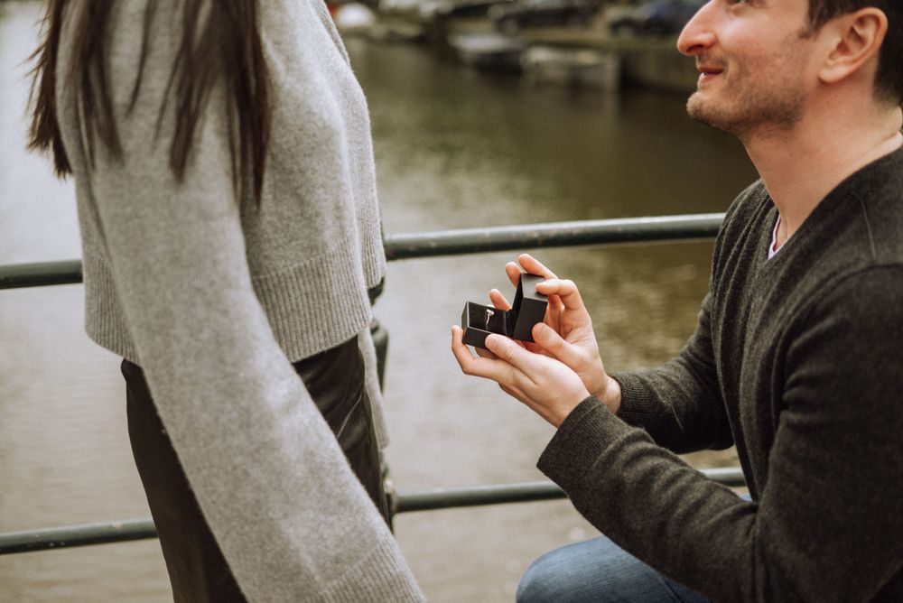 Surprise proposal moment captured by canal in Amsterdam.
