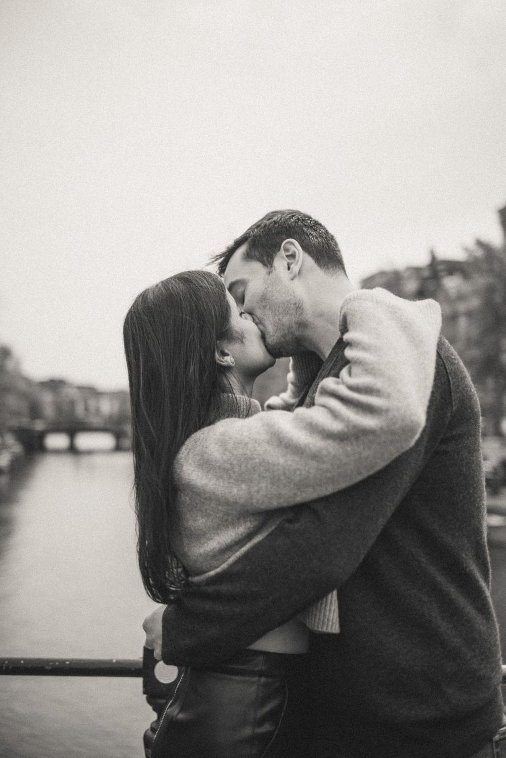 Black and white romantic portrait by Amsterdam canal.