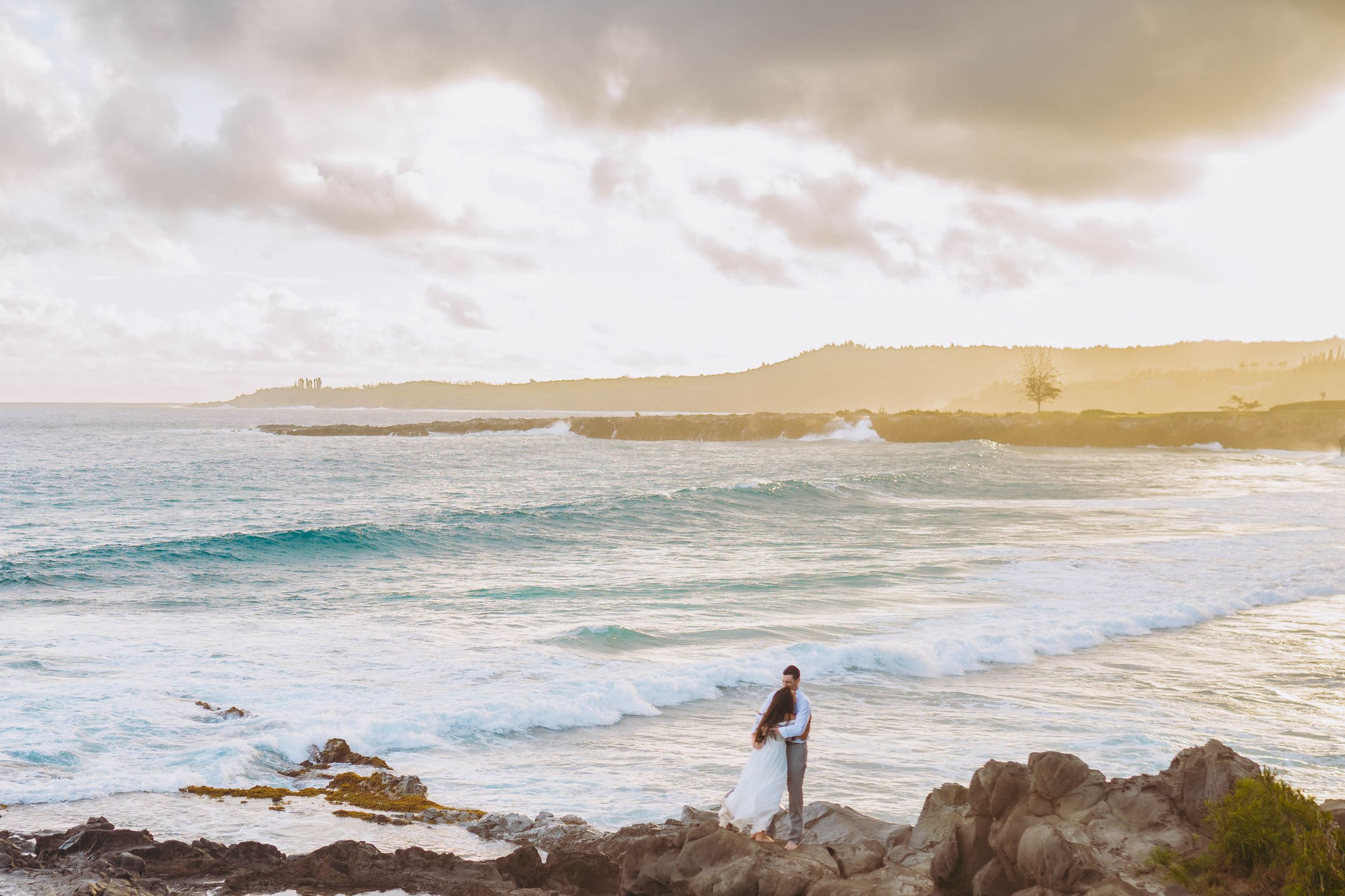 stunning landscape couples photography in maui hawaii. Scenic beach landscape with rocky coastline and golden sunset sky over the ocean.