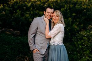 South Maui couples photography at sunset. A couple shares a tender moment together in a garden setting during an engagement photoshoot.