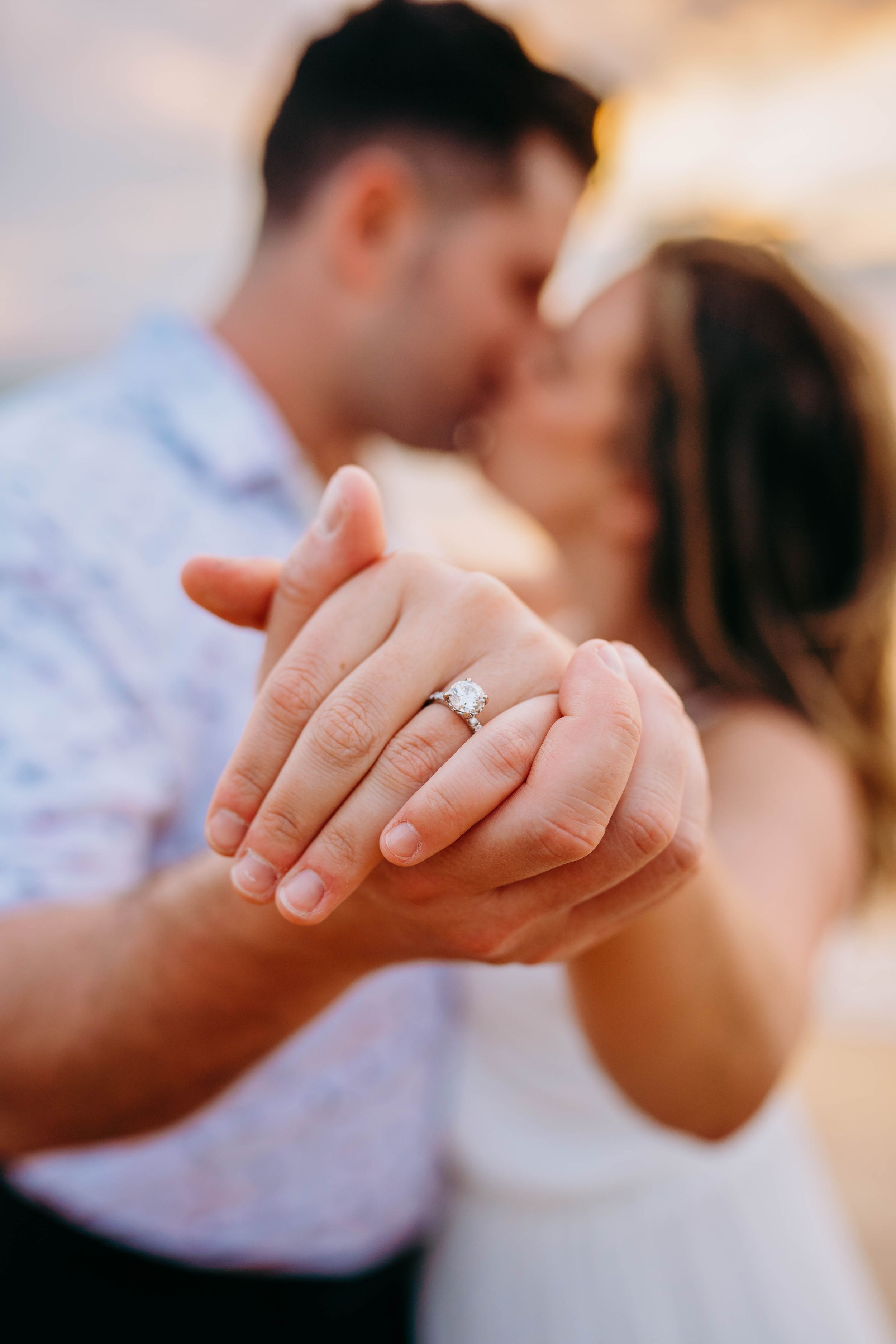 Close-up of engagement ring being displayed on hand with sunset lighting in kaanapali maui for couples photography proposal sunrise family