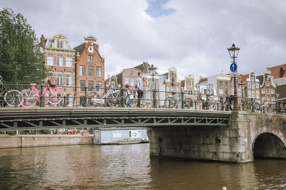 Amsterdam cityscape with bridges and historic architecture along the canal.