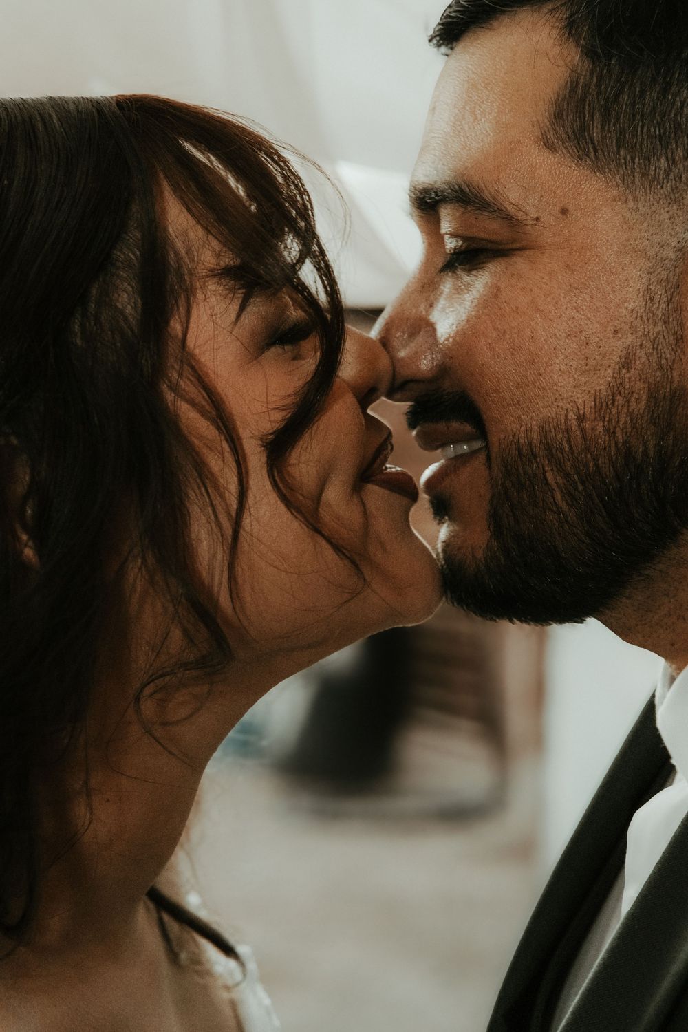 A series of intimate close-up shots showing a couple in formal attire sharing tender moments together.