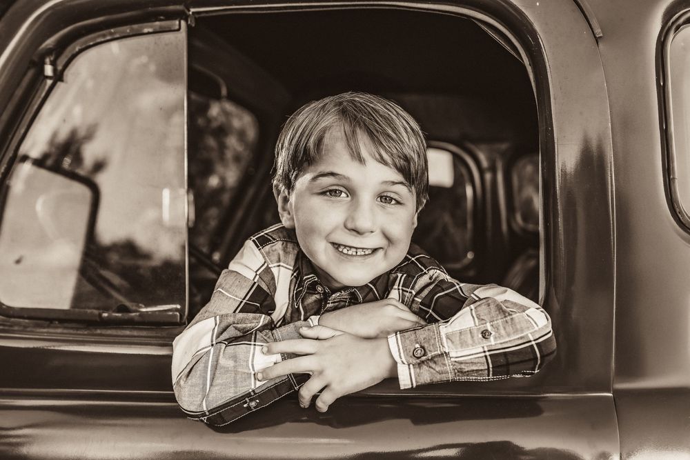 Classic black and white photo series showing views through the window of an antique truck.