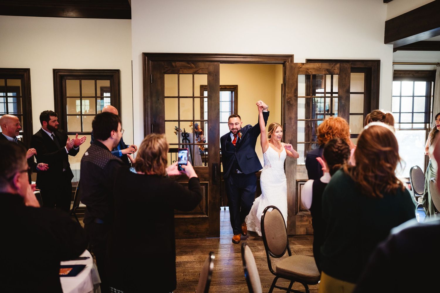 A series of silhouetted figures dancing and mingling at an indoor social gathering with warm lighting and wood paneling.