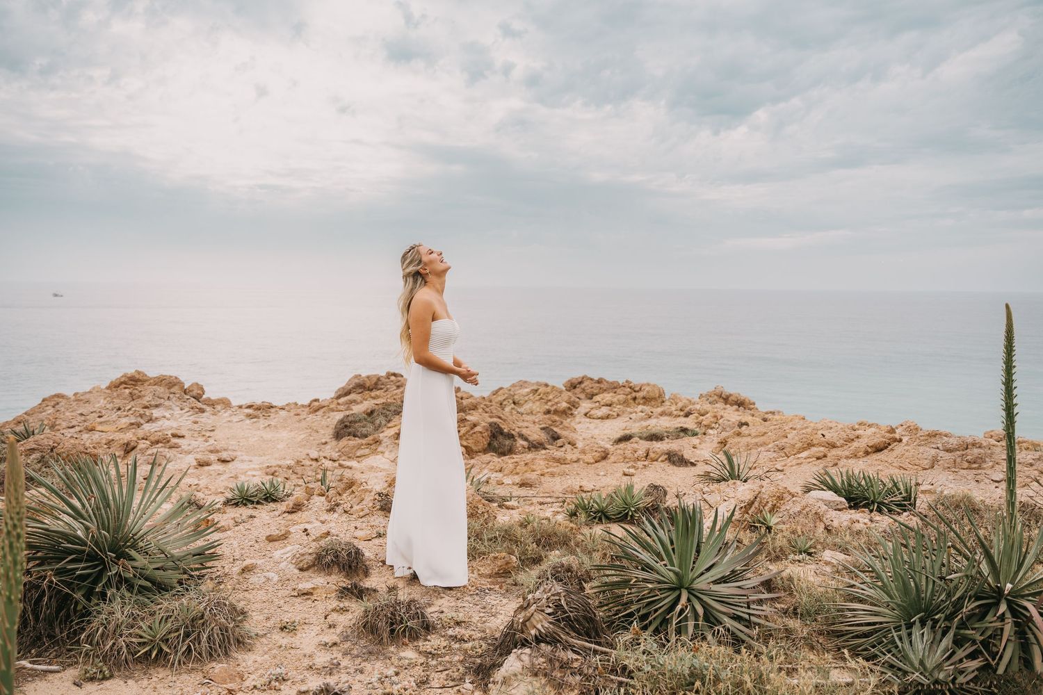 Desert wedding photography with cacti and rock formations in the background.