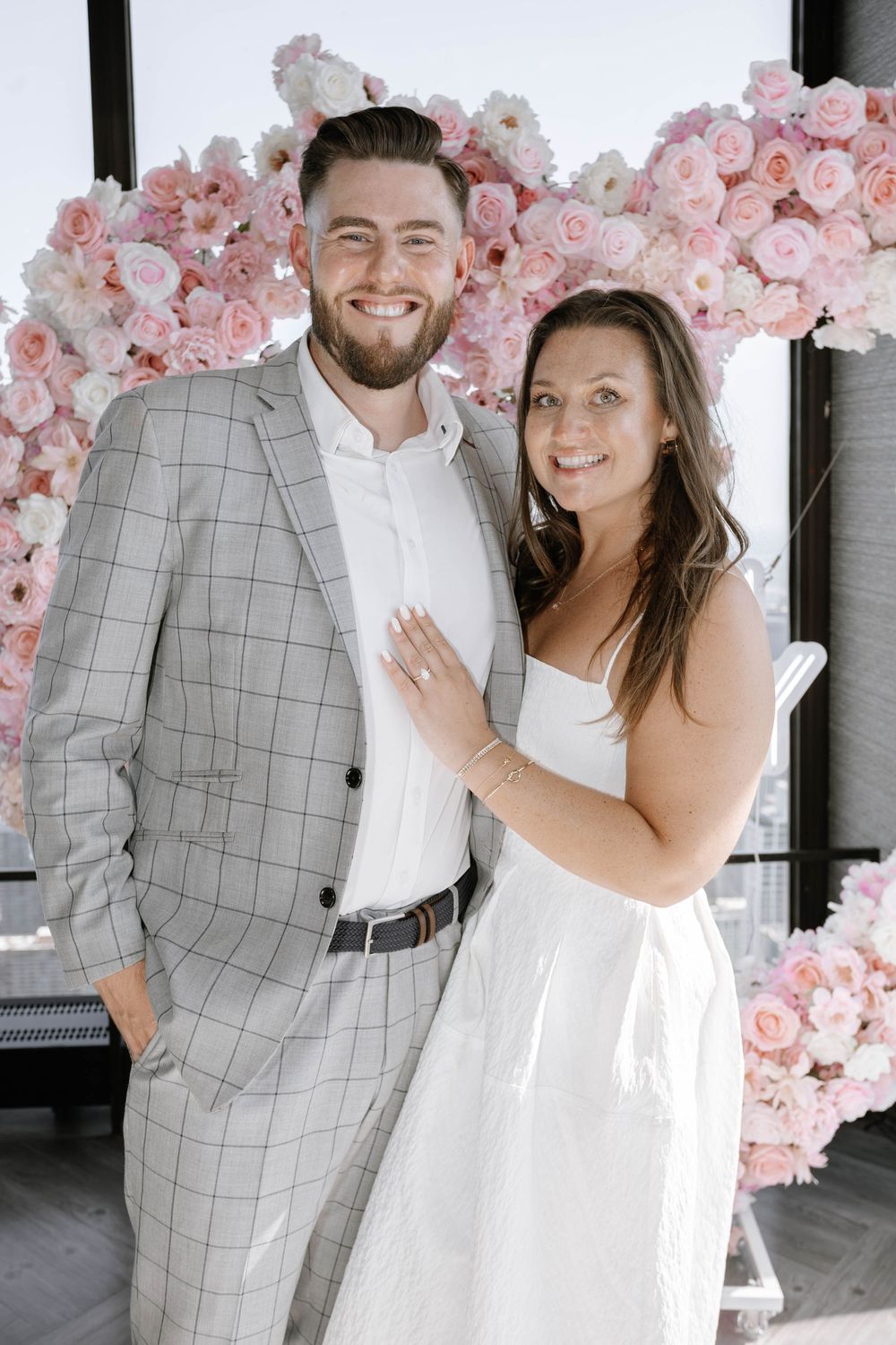 Newlyweds share joyful moments under a pink cherry blossom arch in a romantic wedding photo collage.