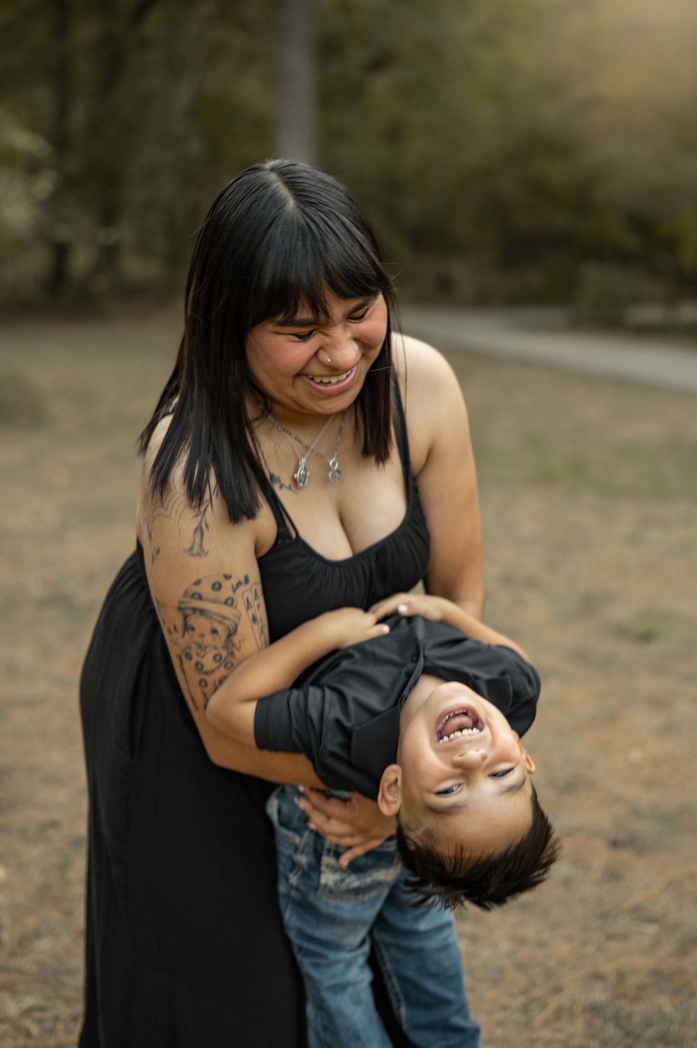 A playful outdoor photoshoot showing candid laughter and joyful moments at sunset.