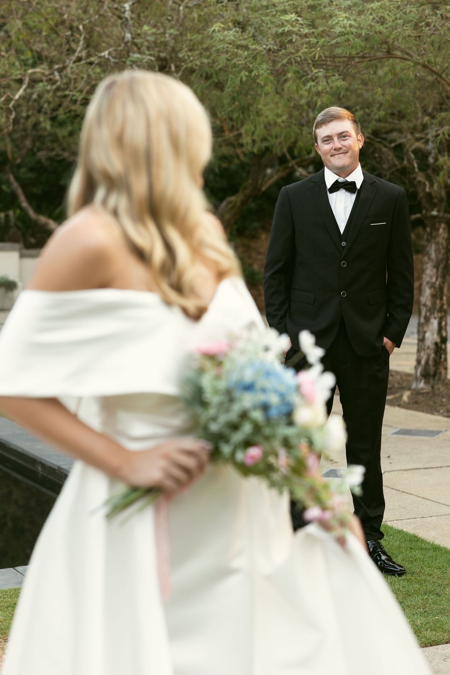 Elegant wedding portraits captured in a garden setting with soft natural lighting.