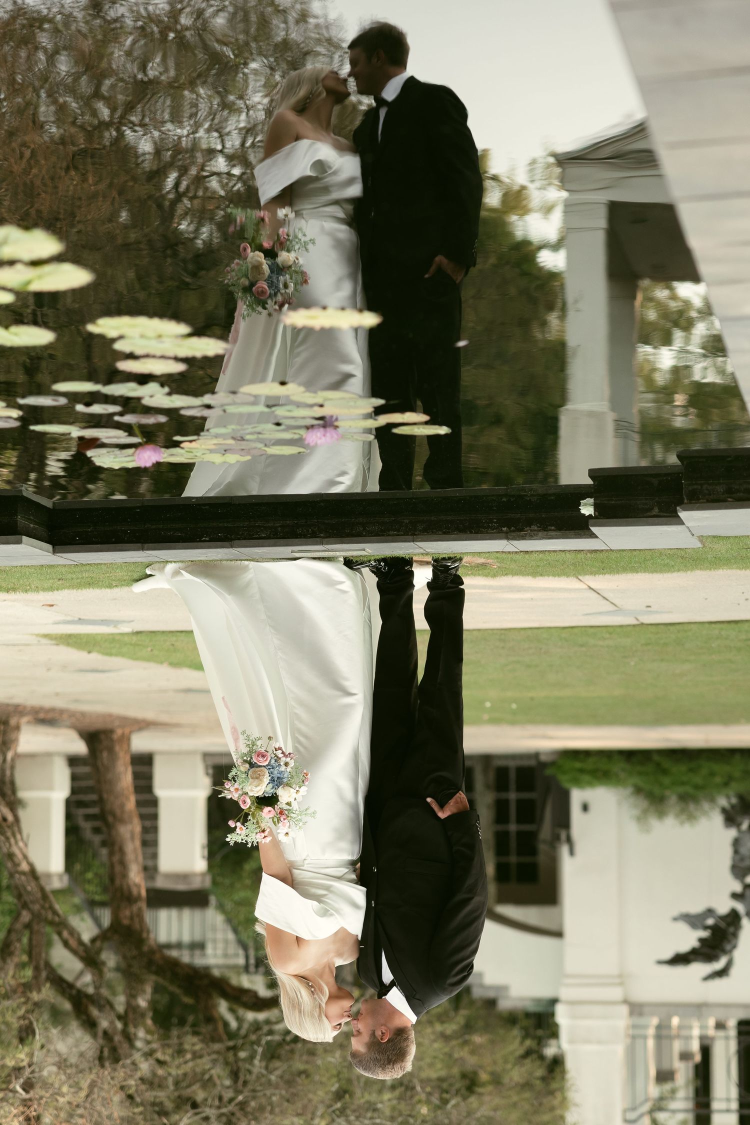 Creative reflection shot of wedding couple in water with architectural elements in background.