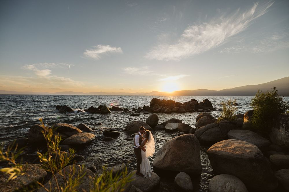 Scenic coastal sunset with rocky shoreline and ocean waves.