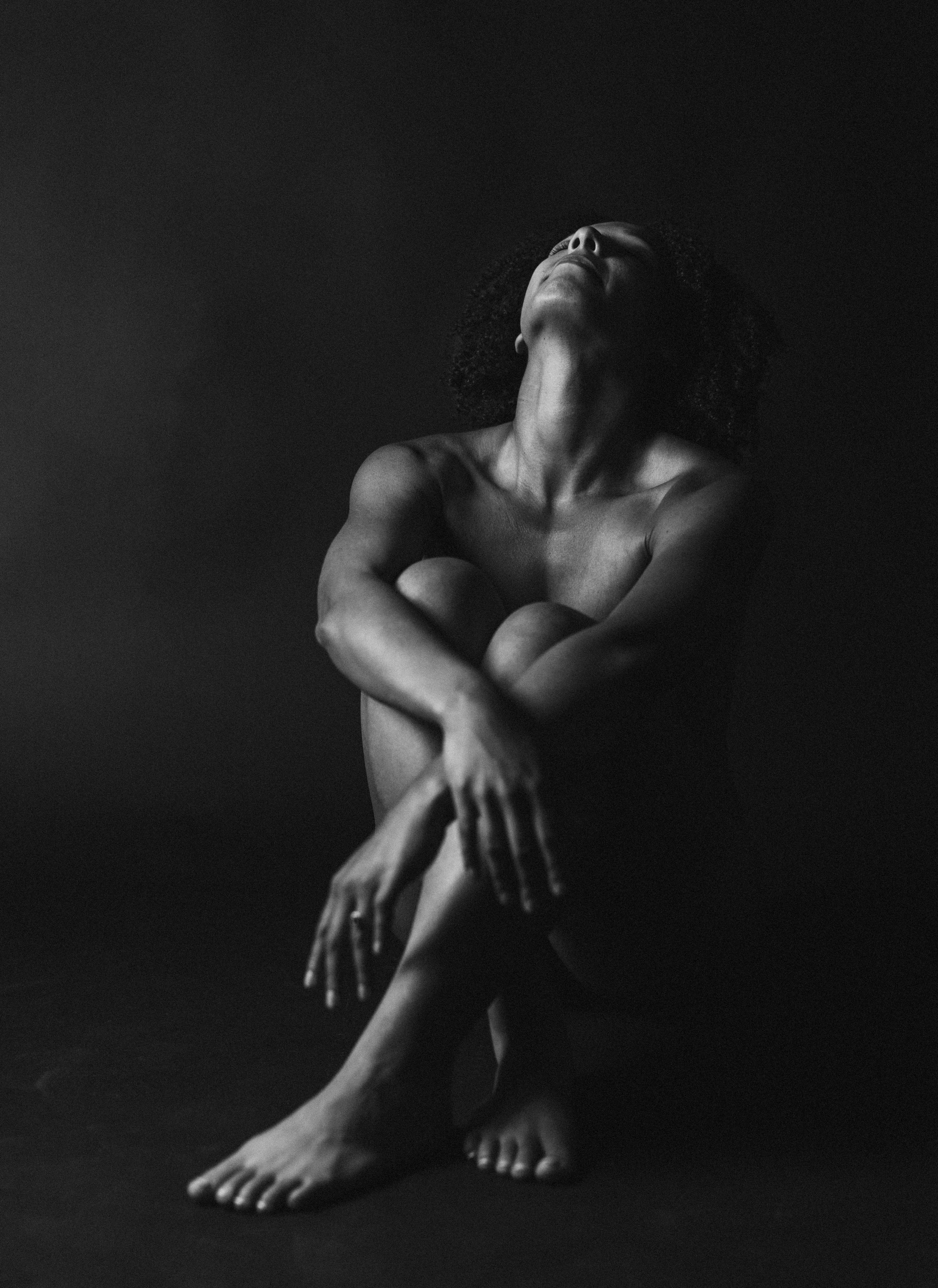 Artistic black and white nude study showing abstract forms and shadows.