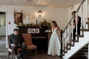 Rustic wedding venue interior with mounted deer head and vintage furniture.