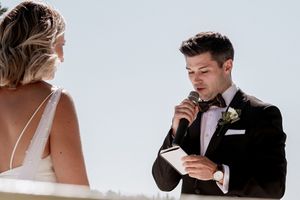Intimate wedding couple portraits against a light background with soft natural lighting.